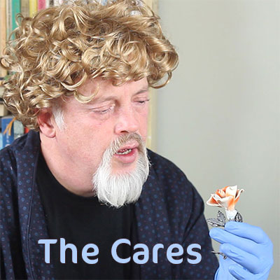 man in a wig holding a flower ornament